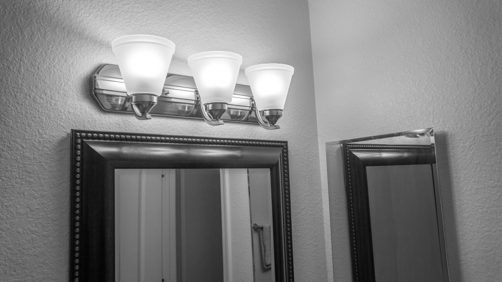 New brushed nickel lighting in guest bathroom